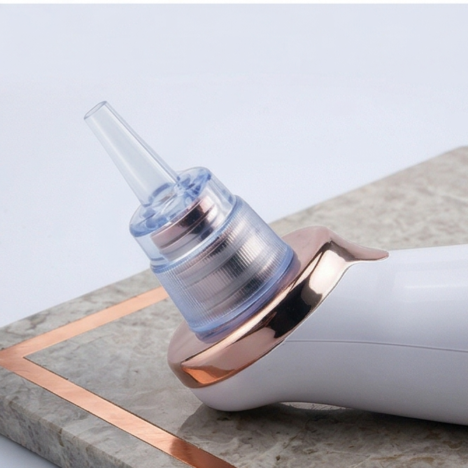 Close-up of a white electronic device with a rose gold accent on a marble surface.